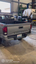 Load and play video in Gallery viewer, a truck parked inside of a garage next to another truck