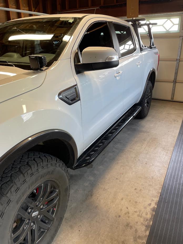 a white truck parked inside of a garage