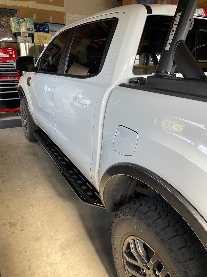 a white truck parked inside of a garage