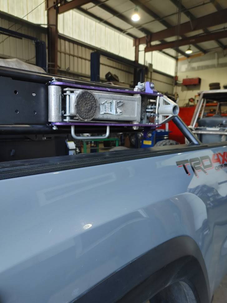 a truck is parked in a garage with other vehicles