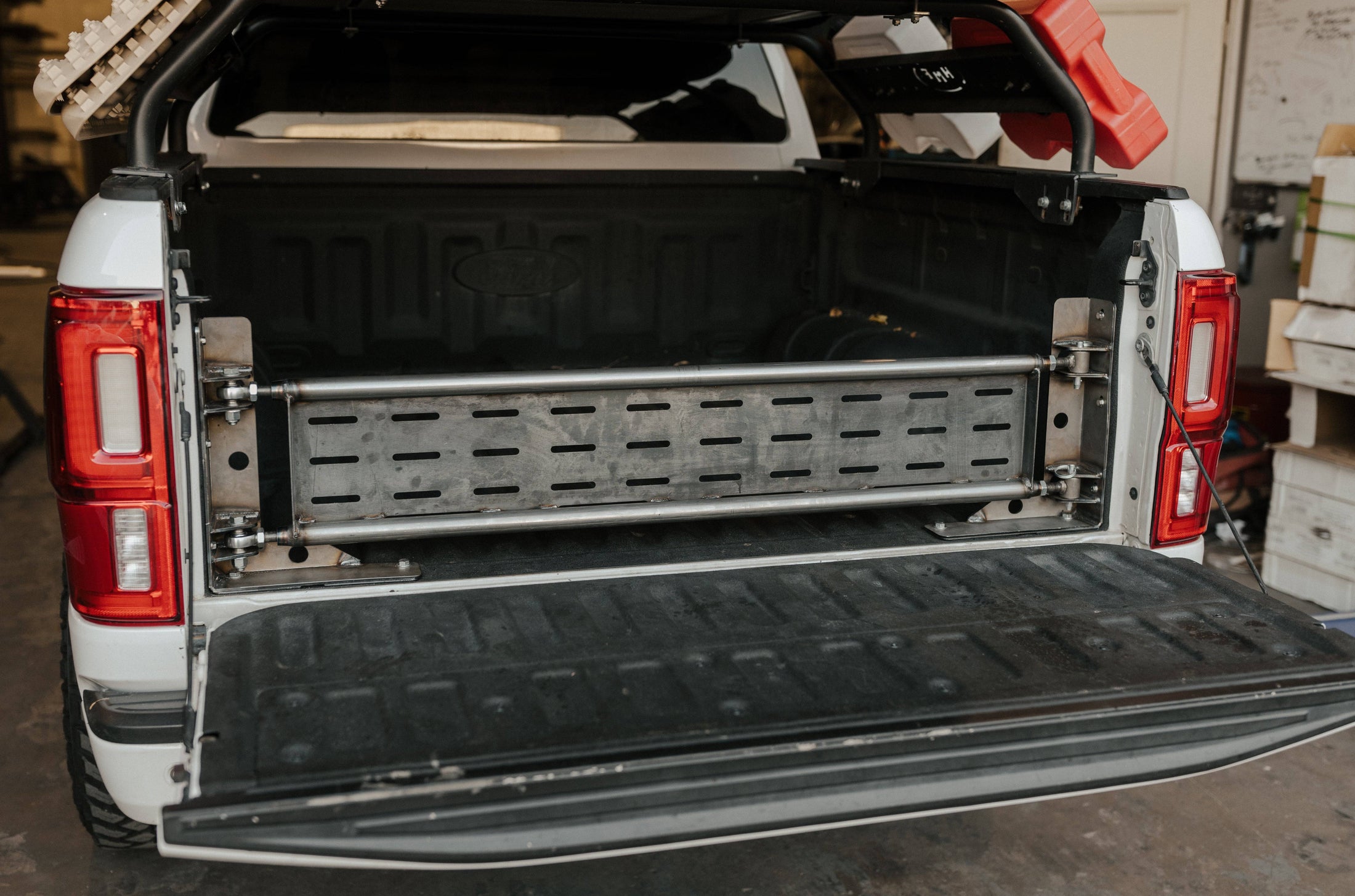 the back end of a white truck with  Internal Tailgate Swingout 