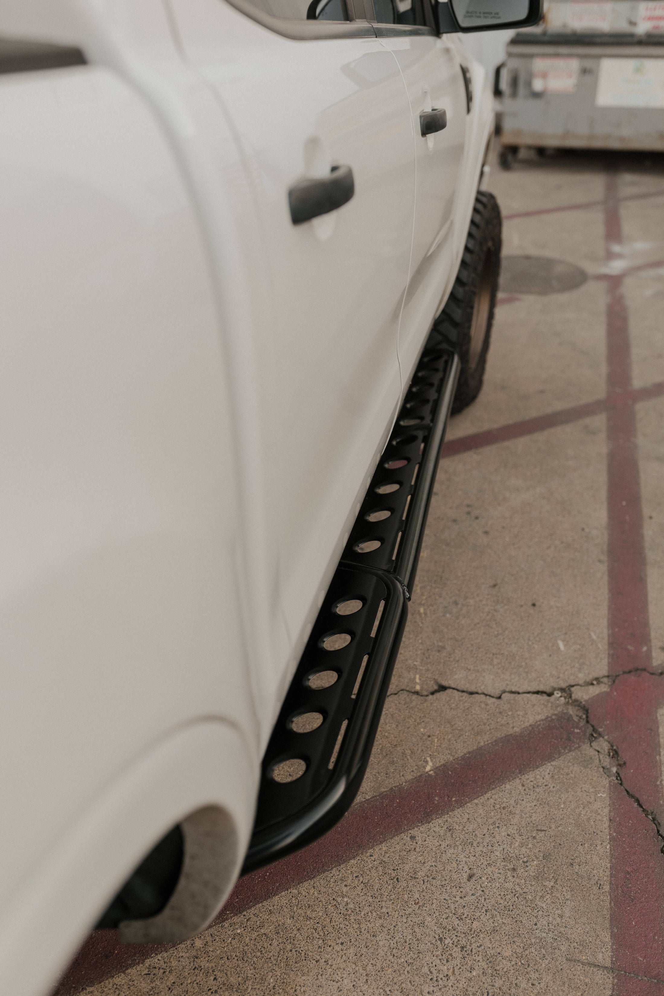 a close up of a white car parked on a street