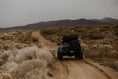 Load image into Gallery viewer, bed rack on a dirt road
