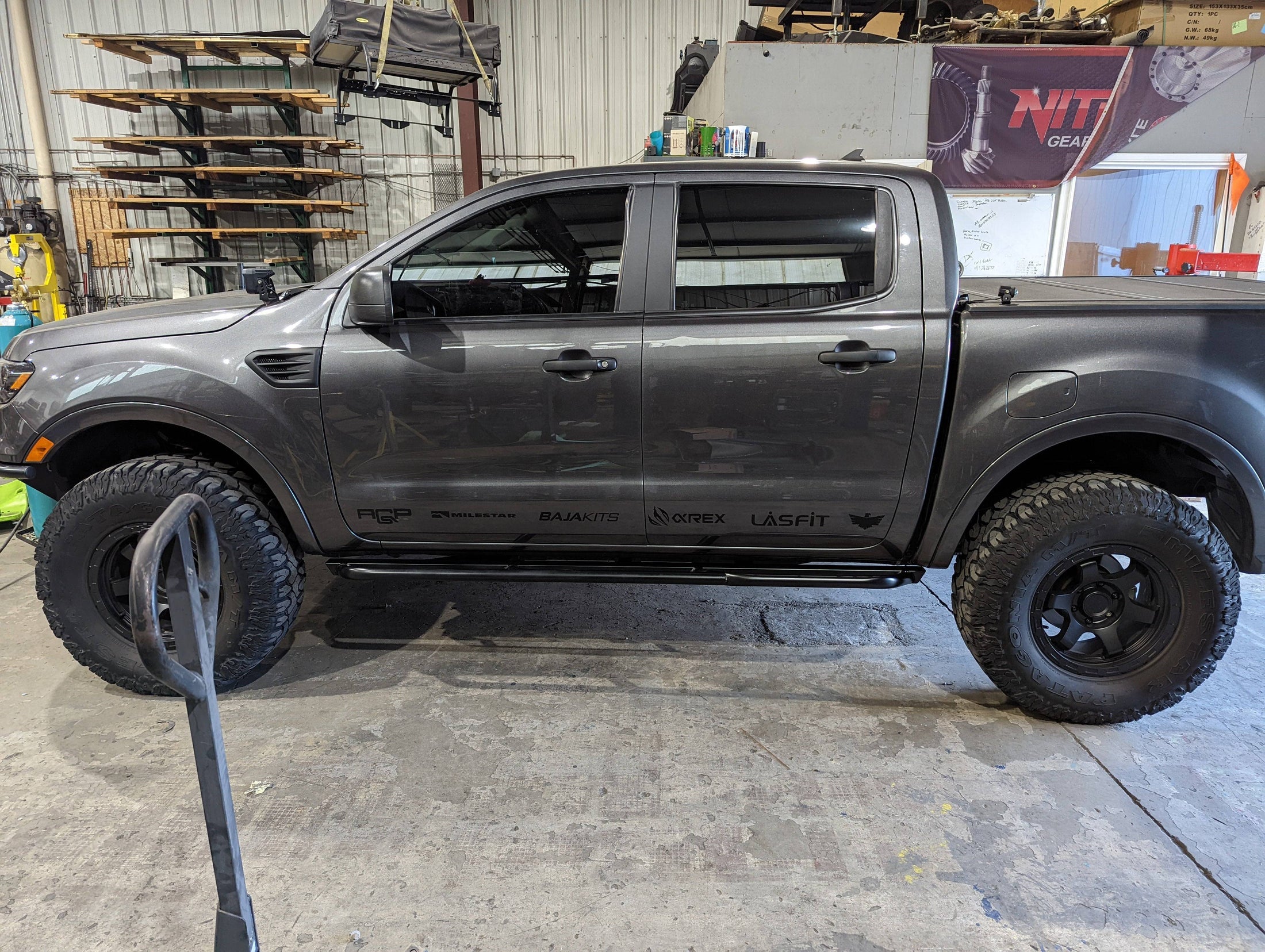 a gray truck parked inside of a garage